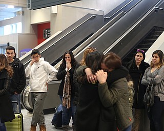 Family members watch as Fidaa Mushleh hugs her daughter Rania Adi goodbye before departing for her flight to reunite with her husband, Al Adi in Amman, Jordan, Wednesday, Feb. 7, 2018, at Cleveland Hopkins International Airport in Cleveland. Adi was deported to Jordan last week after 13 days in ICE detainment...(Nikos Frazier | The Vindicator)