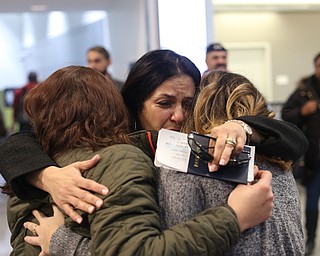 Fidaa Musleh(center) hugs her daughters, Rania(left) and Lina Adi goodbye before departing for her flight to reunite with her husband, Al Adi in Amman, Jordan, Wednesday, Feb. 7, 2018, at Cleveland Hopkins International Airport in Cleveland. Adi was deported to Jordan last week after 13 days in ICE detainment...(Nikos Frazier | The Vindicator)