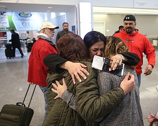 Fidaa Musleh(center) hugs her daughters, Rania(left) and Lina Adi goodbye before departing for her flight to reunite with her husband, Al Adi in Amman, Jordan, Wednesday, Feb. 7, 2018, at Cleveland Hopkins International Airport in Cleveland. Adi was deported to Jordan last week after 13 days in ICE detainment...(Nikos Frazier | The Vindicator)