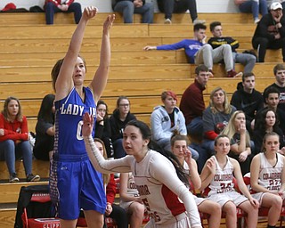 Jackson-Milton guard Grace McDevitt (0) goes up for three as Columbiana's Kennedy Fullum (15) runs by too late to attempt to block her shot in the first quarter of an OHSAA high school basketball game, Thursday, Feb. 8, 2018, in Columbiana. Columbiana won 36-23...(Nikos Frazier | The Vindicator)