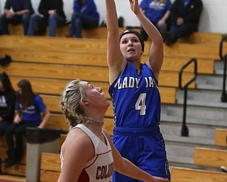 Jackson-Milton guard Camryn Mitchell (4) goes up for two over Columbiana's Tessa Liggett (5) in the second quarter of an OHSAA high school basketball game, Thursday, Feb. 8, 2018, in Columbiana. Columbiana won 36-23...(Nikos Frazier | The Vindicator)