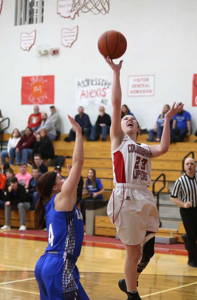 Columbiana's Taylor Hall (23) goes up for a layup past Jackson-Milton guard Camryn Mitchell (4) in the fourth quarter of an OHSAA high school basketball game, Thursday, Feb. 8, 2018, in Columbiana. Columbiana won 36-23...(Nikos Frazier | The Vindicator)