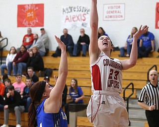 Columbiana's Taylor Hall (23) goes up for a layup past Jackson-Milton guard Camryn Mitchell (4) in the fourth quarter of an OHSAA high school basketball game, Thursday, Feb. 8, 2018, in Columbiana. Columbiana won 36-23...(Nikos Frazier | The Vindicator)