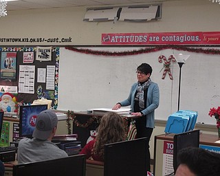 Neighbors | Zack Shively.Principals of Marketing teacher Tina Kinnick addressed her students before the class gave checks to the Salvation Army and Second Harvest Food Bank on Dec. 18. The students sold pepperoni rolls and the funds went to the two charities. The project gave the students a hands-on lesson about the product life cycle.