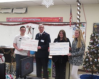 Neighbors | Zack Shively.The students who sold the most pepperoni rolls during the project presented the checks to the charities. Pictured are, from left, student Chris Malloy, Paul Moore of the Salvation Army, Becky Miller of Second Harvest Food Bank and student Destiny Miller. Malloy sold 106 pepperoni rolls and Miller sold 100.