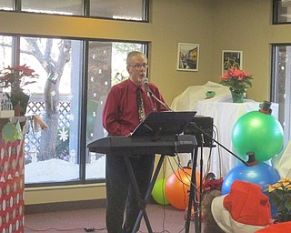 Neighbors | Zack Shively.Dave Pound provided entertainment for the Beeghly Oaks Christmas celebration. He made jokes in between singing classic Christmas songs.