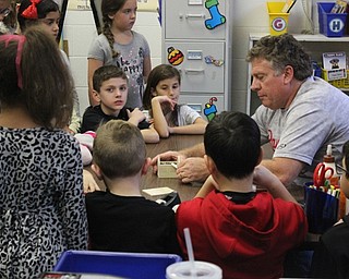 Neighbors | Abby Slanker.Canfield School Board member Barry Tancer instructed C.H. Campbell Elementary School second-grade students in Crystal Schneider’s class on how to build mini wooden gingerbread house ornaments using math skills, giving them step-by-step directions, on Dec. 18.