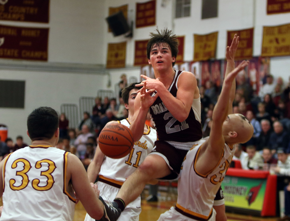             ROBERT  K. YOSAY | THE VINDICATOR..Boardmn at Cardinal Mooney ..Boardmans Cam Kreps gets fouled as he losses the ball during first quarter action #11 Mooney Anthony Fire and#32 Johnie Mikos number 33 Johnny Murphy