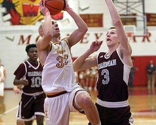             ROBERT  K. YOSAY | THE VINDICATOR..Boardmn at Cardinal Mooney .first quarter action as Mooney #32 Johnnie Mikos goes up for to.as defender Boardman #3 Ryan Archey- behind them #10 Derrick Anderson