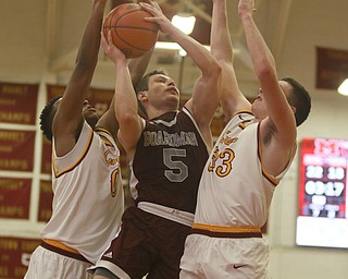             ROBERT  K. YOSAY | THE VINDICATOR..Boardmn at Cardinal Mooney ..Squeeze play Boardman #5 Mike Melewski and  #0 Mooney Terrell Brown and #33  Johnny Murphy s he gets two second quarter action