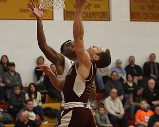             ROBERT  K. YOSAY | THE VINDICATOR..Boardmn at Cardinal Mooney ..Boardman #5 Mike Melewski and Mooney #0 Terrel Brown Collide o the layup by Mike during second quarter action