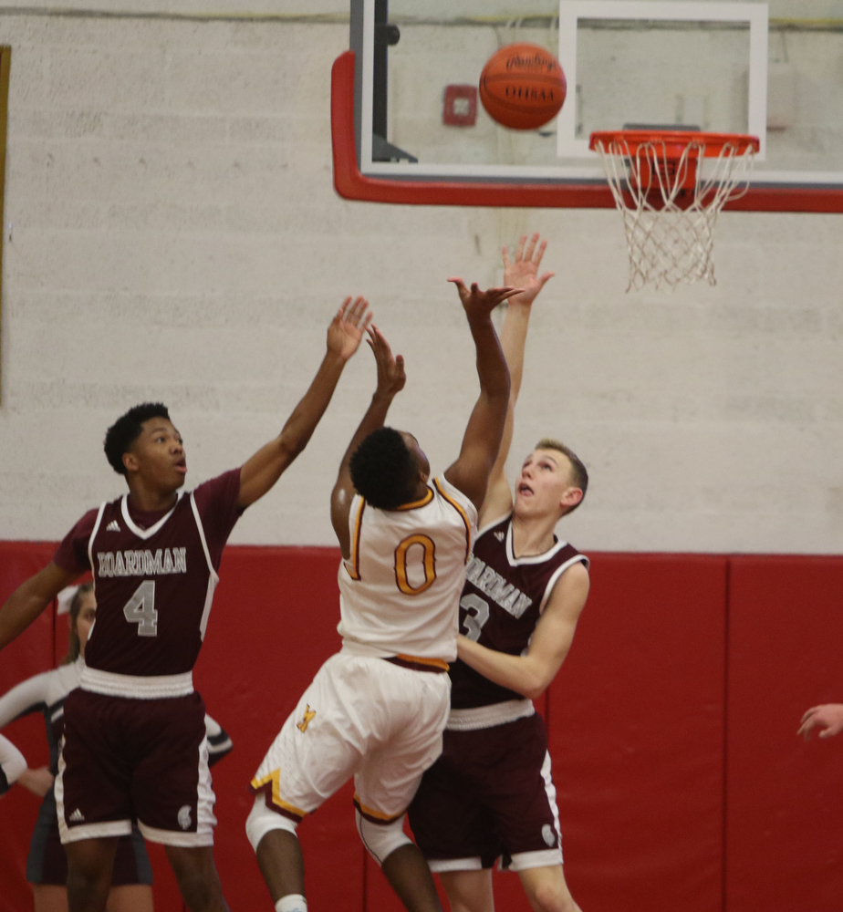             ROBERT  K. YOSAY | THE VINDICATOR..Boardmn at Cardinal Mooney .Mooney #0 Terrel Brown gets blocked by #4 Boardman Mark Phillips and #3 Sonny Rodriquez during second quarter action at mooney