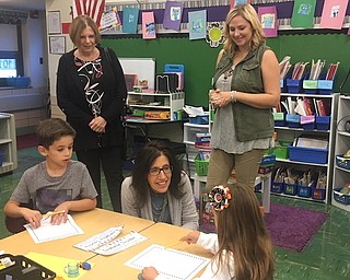 Above, from left, Edie Davidson, BSFEE board member; Joyce Mistovich, BSFEE board president; and Heidi Peachock, first-grade teacher at Stadium Drive Elementary School, help students work with interactive learning tools purchased with a mini grant.