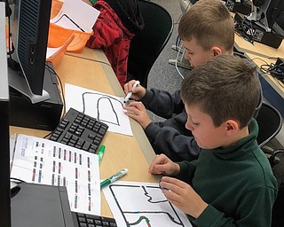 Damascus Elementary School students recently participated in an international program focused on introducing students to computer science, programming and computational thinking known as the “Hour of Code.” The students spend one hour using an Ozobot, a small robot that can be programmed using ink-based codes compiled via a Chromebook or iPad. Caitlin Reash, Damascus principal, led the effort with the help of Pamela Denny, library/technology teacher, and Jacqueline Mumford, professor of graduate education (computers and technology) at Walsh University. Above, front to back, are Aiden Handy and Owen Martin, third-grade students who participated. Below, front to back, are Rory Rohaley and Sadie Weaver, kindergarten students.