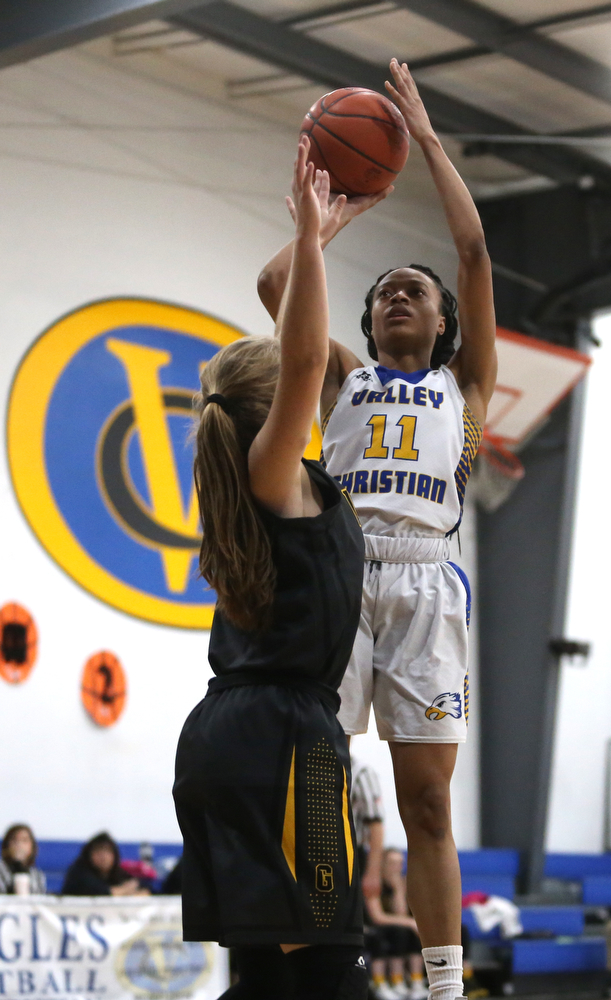 Valley Christian's Imane Snyder (11) goes up over Garfield's Emma Trent (12) for two in the third quarter of an OHSAA high school basketball game, Saturday, Feb. 10, 2018, in Youngstown. Garfield won 64-58...(Nikos Frazier | The Vindicator)