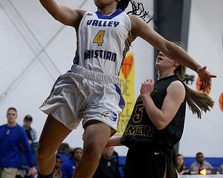 Valley Christian's Kristen Gill (4) goes up for a layup past Garfield's Grace Mills (5) in the third quarter of an OHSAA high school basketball game, Saturday, Feb. 10, 2018, in Youngstown. Garfield won 64-58...(Nikos Frazier | The Vindicator)