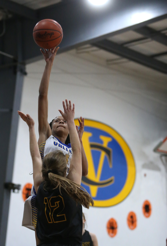 Valley Christian's Imane Snyder (11) goes up for a layup over Garfield's Emma Trent (12) in the fourth quarter of an OHSAA high school basketball game, Saturday, Feb. 10, 2018, in Youngstown. Garfield won 64-58...(Nikos Frazier | The Vindicator)