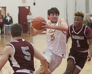             ROBERT  K. YOSAY | THE VINDICATOR..Boardmn at Cardinal Mooney ..#5 Mooney Pete Haas   drives between Boadmna #5 Mike Melewski and #1  Jajuante  Young  during first quarter action