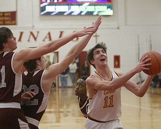             ROBERT  K. YOSAY | THE VINDICATOR..Boardmn at Cardinal Mooney ..Mooney #11Anthony fire andBoardman 21 Com Kreps and #32 Conner Miller as he puts in two during first quarter action