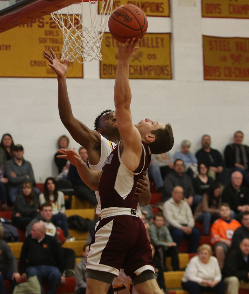             ROBERT  K. YOSAY | THE VINDICATOR..Boardmn at Cardinal Mooney ..Boardman #5 Mike Melewski and Mooney #0 Terrel Brown Collide o the layup by Mike during second quarter action