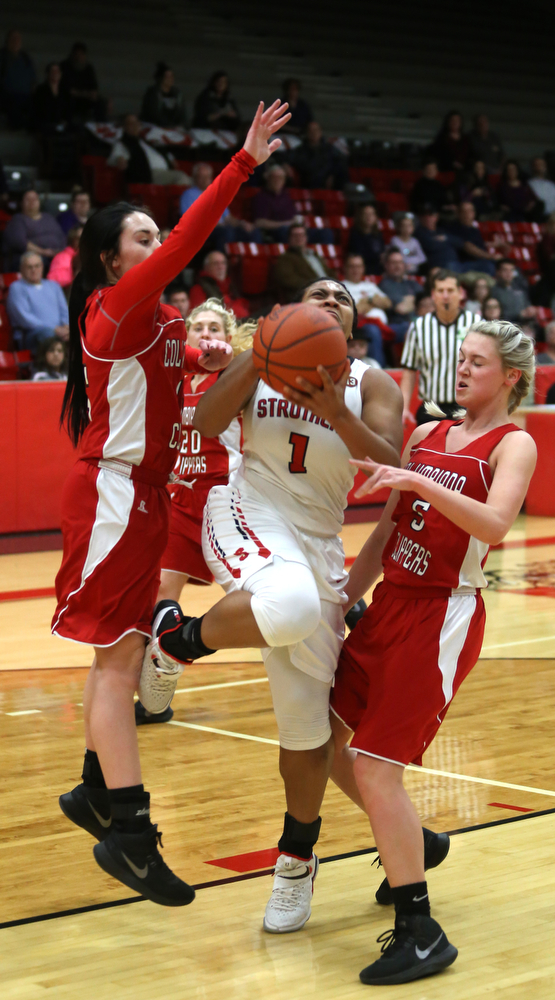 Struthers' Khaylah Brown (1) goes between Columbiana's Kennedy Fullum (15) and Columbiana's Tessa Liggett (5) for a layup in the first quarter of an OHSAA high school basketball game, Monday, Feb. 12, 2018, in Struthers. Struthers won 61-52...(Nikos Frazier | The Vindicator)