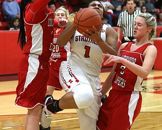 Struthers' Khaylah Brown (1) goes between Columbiana's Kennedy Fullum (15) and Columbiana's Tessa Liggett (5) for a layup in the first quarter of an OHSAA high school basketball game, Monday, Feb. 12, 2018, in Struthers. Struthers won 61-52...(Nikos Frazier | The Vindicator)