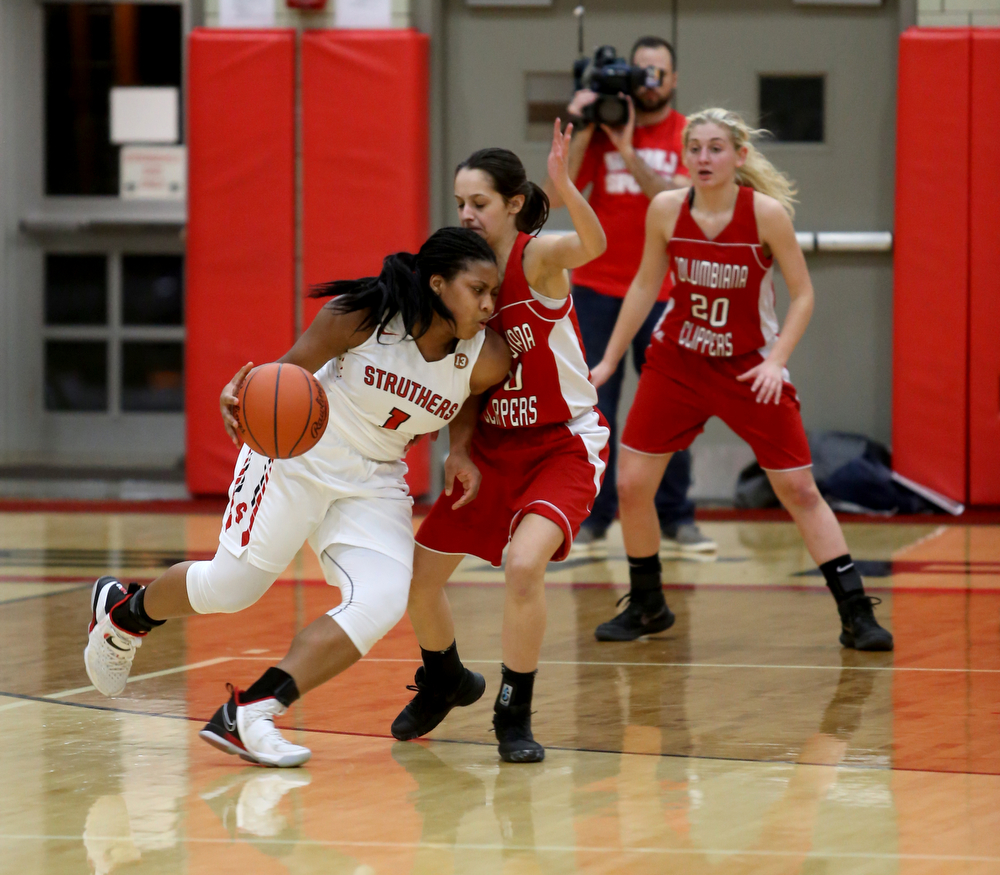 Struthers' Khaylah Brown (1) dribbles into Columbiana's Grace Hammond (10) in the second quarter of an OHSAA high school basketball game, Monday, Feb. 12, 2018, in Struthers. Struthers won 61-52...(Nikos Frazier | The Vindicator)