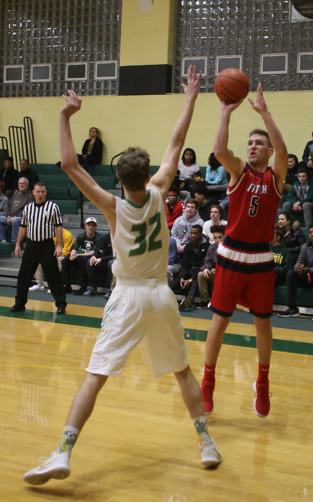 Austintown Fitch forward Cole Constance (5) goes up for three over Ursuline forward Ethan Courtney (32) in the first quarter of an OHSAA high school basketball game, Tuesday, Feb. 13, 2018, in Youngstown. Ursuline won 63-58...(Nikos Frazier | The Vindicator)