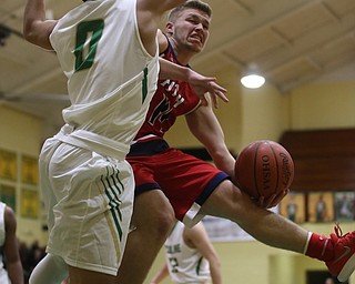 Austintown Fitch fowrard Kole Klasic (14) layup is blocked by Ursuline forward Devan Keevey (0) in the first quarter of an OHSAA high school basketball game, Tuesday, Feb. 13, 2018, in Youngstown. Ursuline won 63-58...(Nikos Frazier | The Vindicator)