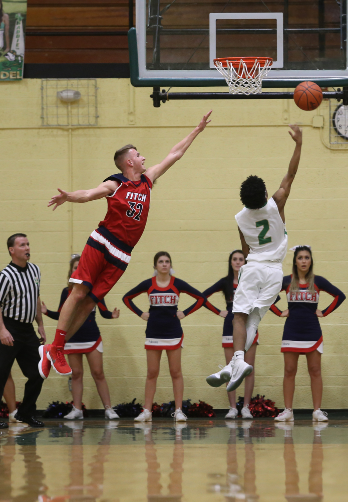 Ursuline guard DeShawn Harris (2) hooks a layup as Austintown Fitch center Nick Belcik (32) reaches out in an attempt to block his shot in the first quarter of an OHSAA high school basketball game, Tuesday, Feb. 13, 2018, in Youngstown. Ursuline won 63-58...(Nikos Frazier | The Vindicator)