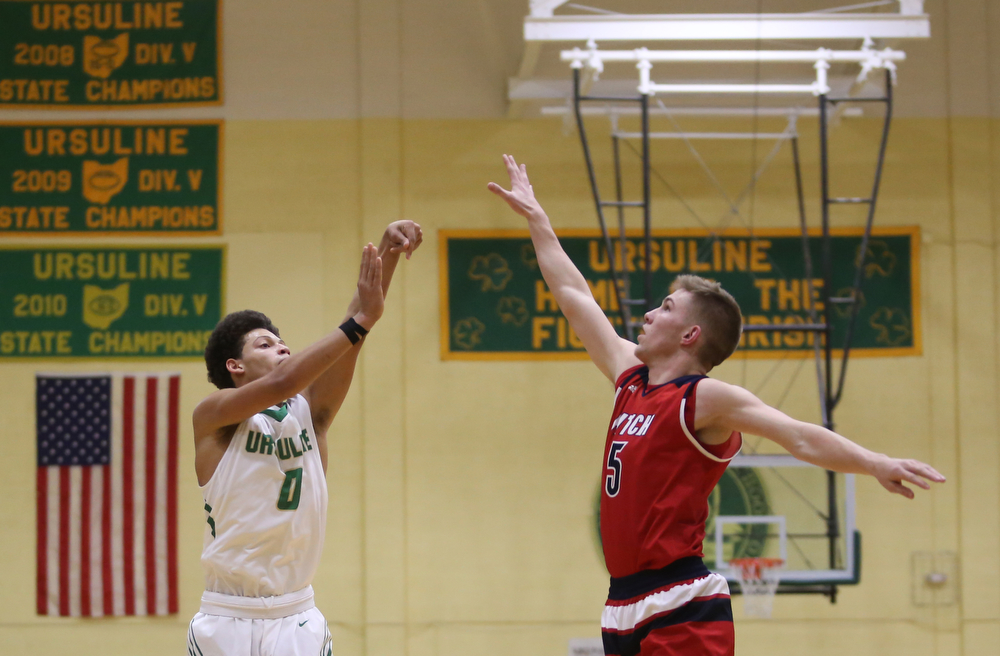 Ursuline forward Devan Keevey (0) goes up for three over Austintown Fitch forward Cole Constance (5) in the second quarter of an OHSAA high school basketball game, Tuesday, Feb. 13, 2018, in Youngstown. Ursuline won 63-58...(Nikos Frazier | The Vindicator)