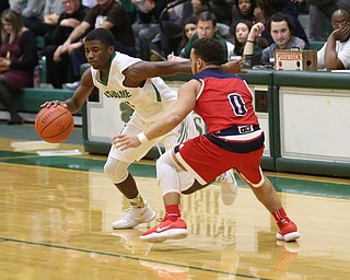 Ursuline guard Nicolas Venzeio (11) drives past Austintown Fitch forward Randy Smith (0) in the second quarter of an OHSAA high school basketball game, Tuesday, Feb. 13, 2018, in Youngstown. Ursuline won 63-58...(Nikos Frazier | The Vindicator)