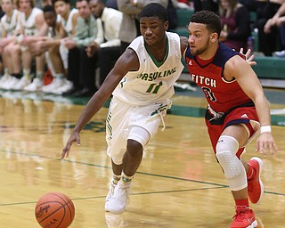 Ursuline guard Nicolas Venzeio (11) drives past Austintown Fitch forward Randy Smith (0) in the second quarter of an OHSAA high school basketball game, Tuesday, Feb. 13, 2018, in Youngstown. Ursuline won 63-58...(Nikos Frazier | The Vindicator)