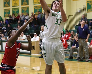 Ursuline forward Luke Pipala (33) goes up for a layup past Austintown Fitch guard Emaniel Dawkins (11) in the second quarter of an OHSAA high school basketball game, Tuesday, Feb. 13, 2018, in Youngstown. Ursuline won 63-58...(Nikos Frazier | The Vindicator)