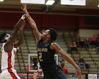 Youngstown State guard Jeremiah Ferguson (5) goes up for three as Oakland guard Nick Daniels (2) attempts to block his shot in the first half of an NCAA Horizon League college basketball game, Wednesday, Feb. 14, 2018, in Youngstown. YSU won 75-73...(Nikos Frazier | The Vindicator)