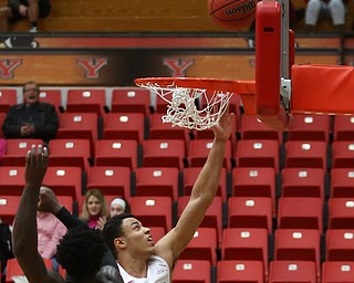 Youngstown State forward Noe Anabir (21) goes up for a layup past Oakland guard Kendrick Nunn (1) in the first half of an NCAA Horizon League college basketball game, Wednesday, Feb. 14, 2018, in Youngstown. YSU won 75-73...(Nikos Frazier | The Vindicator)