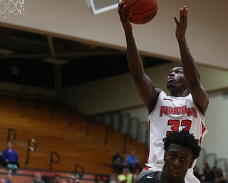 Youngstown State guard Garrett Covington (32) goes up for a layup over Oakland guard Kendrick Nunn (1) in the second half of an NCAA Horizon League college basketball game, Wednesday, Feb. 14, 2018, in Youngstown. YSU won 75-73...(Nikos Frazier | The Vindicator)