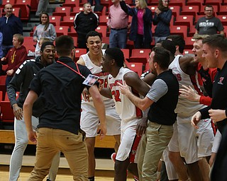 The YSU bench swarms Youngstown State guard Garrett Covington (32) after his buzzer beater basket in the second half of an NCAA Horizon League college basketball game, Wednesday, Feb. 14, 2018, in Youngstown. YSU won 75-73...(Nikos Frazier | The Vindicator)