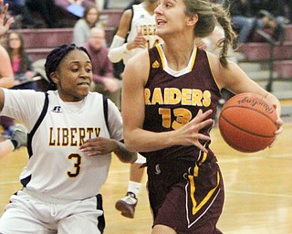 William D. Lewis The Vindicator   South Range's Maddie Durkin(13) shoots over Liberty's China Tate(3) during 2-14-18 action at Liberty.