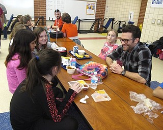 Neighbors | Zack Shively.Austintown Intermediate School observed No One Eats Alone Day a national program created by Beyond Differences, on Feb. 9. Pictured, Dean of Students Mick Naples sat with fifth-grade students during the event.