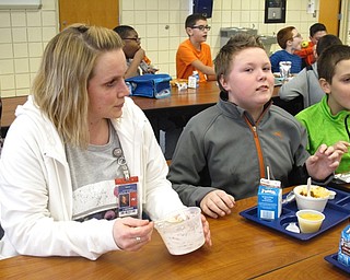 Neighbors | Zack Shively.Michael Sauner, principal of Austintown Intermediate School, believes in the No One Eats Alone Day program. He said the program extends students' range of support. Pictured, fifth-grade intervention teacher Jessie Geiser ate with a group of students.