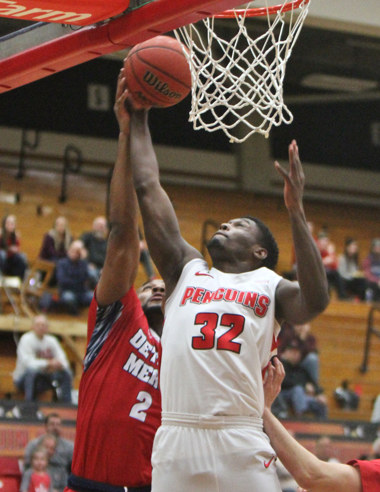 William D. Lewis The Vindicator  YSU'sGarrett Covington(32) shoots past  Detroit's Roschon Prince(2) during 2-16-18 action at YSU.