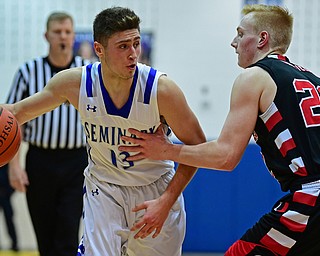 POLAND, OHIO - FEBRUARY 16, 2018: Poland's Brandon Barringer drives on Canfield's Ian McGraw during the first half of their game on Friday night at Poland Seminary High School. DAVID DERMER | THE VINDICATOR