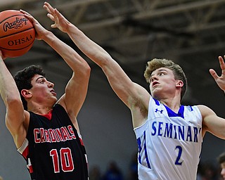 POLAND, OHIO - FEBRUARY 16, 2018: Canfield's Conor Grogan shoots against Poland's Mike Diaz during the second half of their game on Friday night at Poland Seminary High School. DAVID DERMER | THE VINDICATOR