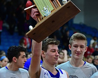 POLAND, OHIO - FEBRUARY 16, 2018: Poland's Billy Orr celebrates with the "Battle of 224" trophy after Poland defeated Canfield, Friday night at Poland Seminary High School. DAVID DERMER | THE VINDICATOR