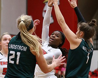 YOUNGSTOWN, OHIO - FEBRUARY 17, 2018: YSU Penguins' Indiyan Benjamin (3) hooks a shot over Green Bay Phoenix's Jen Wellnitz (1) and Jessica Lindstrom (21) during the 1st qtr. at Beeghly Center, YSU, Youngstown, OH.  MICHAEL G. TAYLOR | THE VINDICATOR