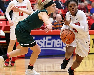 YOUNGSTOWN, OHIO - FEBRUARY 17, 2018: YSU Penguins' Indiyan Benjamin (3) drives by Green Bay Phoenix's Jessica Lindstrom (21) during the 3rd qtr. at Beeghly Center, YSU, Youngstown, OH.  MICHAEL G. TAYLOR | THE VINDICATOR