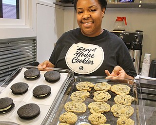 TaRee Avery, owner and operator of Dough House Cookies, poses for a photo with a batch of Wakanda Whoopie Pies, and chocolate chip and oatmeal raisin cookies. Half the sales from her whoopie pies – red velvet cookies dyed black, with a whipped cream cheese filling – will go toward sending children from low-income households to see the Marvel blockbuster movie “Black Panther.” 