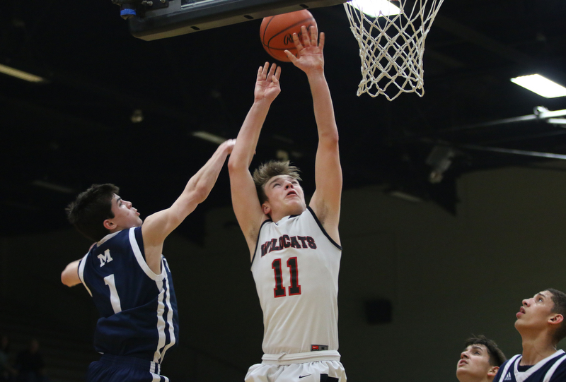 Trey Metzka (11) of Struthers goes up for a layup while being defended by Zach Rasile (1) during the first half of Tuesday nights matchup at Struthers Field House.  Dustin Livesay  |  The Vindicator  2/20/18 Struthers