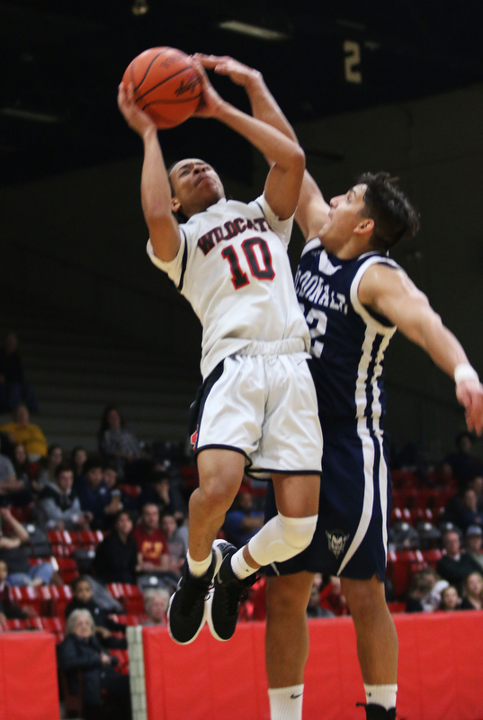 Adrian Brown (10) of Struthers goes up for a shot while being defended McDonald's Matthew Beedle (32) during the first half of Tuesday nights matchup at Struthers Field House.  Dustin Livesay  |  The Vindicator  2/20/18 Struthers